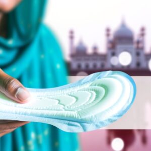 A close-up image of a worker in a sanitary pad manufacturing facility in Kolkata, India. They are carefully inspecting a batch of sanitary pads before they are packaged and distributed. The image emphasizes the importance of quality control and hygiene standards in the production of these essential feminine hygiene products.