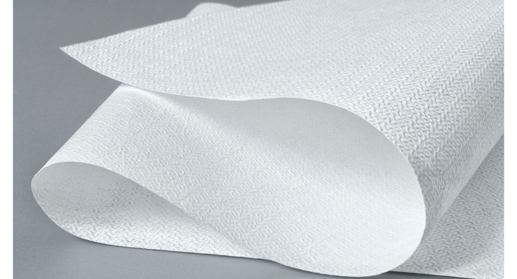 A stack of professional-grade industrial wipes fabric with a focus on their textured surface, representing durability and high absorbency for use in tough environments like automotive and printing.