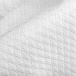 A close-up of the textured surface of diamond embossed spunlace nonwoven fabric, highlighting its softness and the detailed hydroentangled pattern from Favourite Fab.