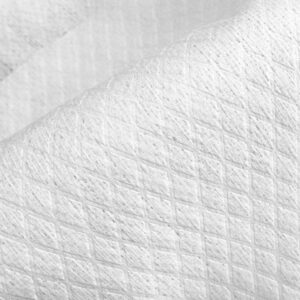 A close-up of the textured surface of diamond embossed spunlace nonwoven fabric, highlighting its softness and the detailed hydroentangled pattern from Favourite Fab.