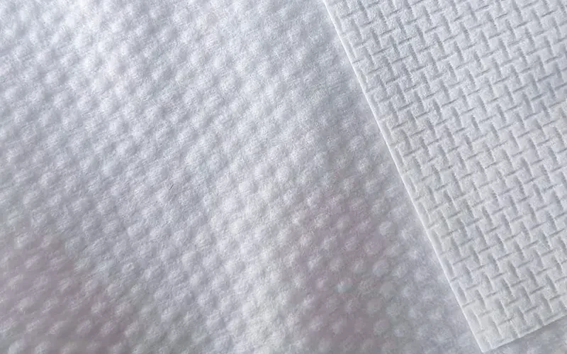 A detailed shot of a roll of diamond embossed spunlace fabric, showcasing the distinct diamond texture and high-quality finish.