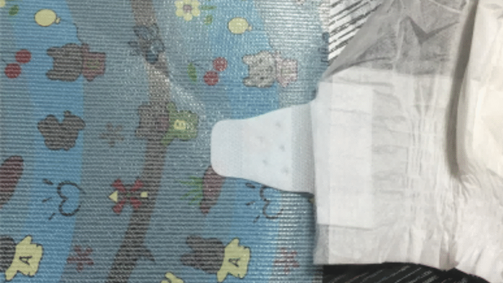 An illustration showing the step-by-step process of how is diaper front tape made, from raw materials to a finished roll.