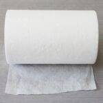 A close-up shot of a single wipe from the High Absorbent 100% Viscose Embossed Spunlace Non-Woven Fabric product line, clearly showing the textured embossed pattern and material quality.