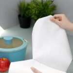A close-up shot of a single wipe from the household embossed spunlace wipes product line, clearly showing the textured embossed pattern and material quality.
