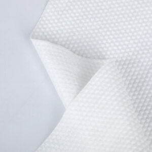 A large industrial roll of Polyester and Blended Spunlace Fabric, showcasing its pristine white color and smooth, uniform texture, manufactured by Favourite Fab.