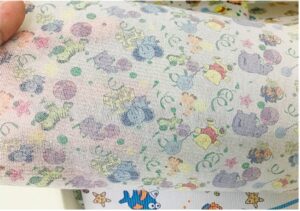 A close-up shot of Print Paper Frontal Tape for Diaper from Favourite Fab, showcasing a vibrant custom printed design on the paper surface.