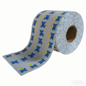 A close-up view of printed brushed frontal tapes disposable diaper raw materials on a large jumbo roll. The image shows the soft texture and a vibrant custom print, highlighting its quality and branding potential.
