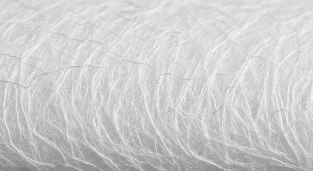 A close-up shot of high-quality spunlace nonwoven fabric, showcasing the texture and strength produced by leading spunlace manufacturers in Hyderabad. The image highlights the detailed and meticulous hydroentanglement process.