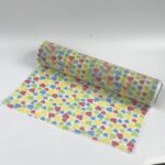 Large jumbo roll of repeating Pattern Non Woven Printed Fabric, illustrating production scale for custom printed spunbond and flexographic printing.
