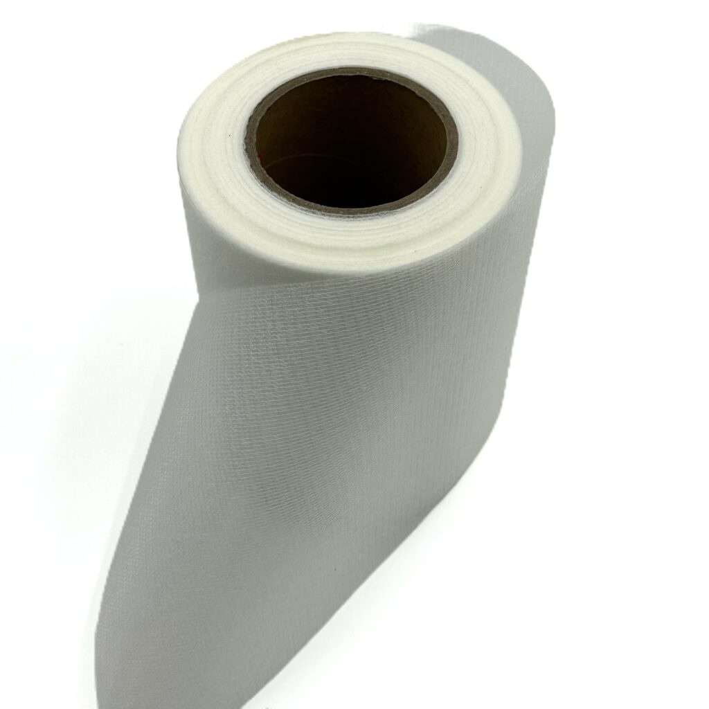 A close-up shot of a manufactured roll of loop frontal tape, illustrating the textured, soft loop material used for high-performance diaper fasteners.