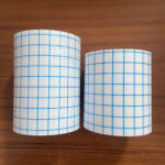 Macro shot of the non woven spunlace adhesive tape surface, clearly showing the porous, breathable non-woven adhesive roll structure.