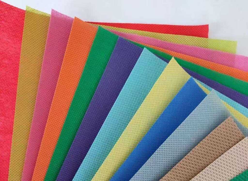A macro photograph showcasing a sample of custom patterned nonwoven fabric, highlighting its aesthetic embossed design and superior tactile texture engineered for specialized commercial applications.